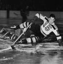 <p>BOSTON, MA – JANUARY 17: Milt Schmidt #15 of the Boston Bruins falls on Bill Moe of the New York Rangers during a struggle for the puck on January 17, 1946 at the Boston Garden in Boston, Massachusetts. (Photo by Bruce Bennett Studios/Getty Images) </p>