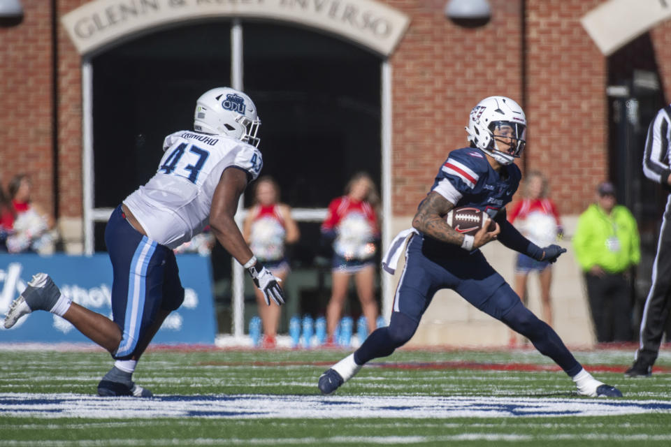 Liberty's Kaidon Salter tries to run past Old Dominion's Kris Trinidad (43) during the first half of an NCAA college football game, Saturday, Nov. 11, 2023, in Lynchburg, Va. (AP Photo/Robert Simmons)