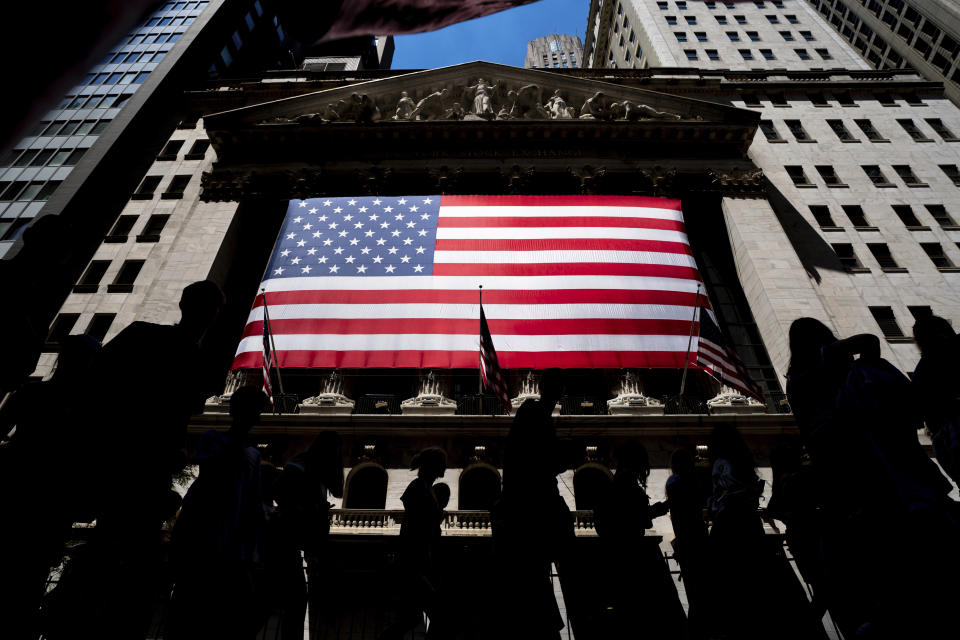 People walk past the New York Stock Exchange on Wednesday, June 29, 2022 in New York. (AP Photo/Julia Nikhinson)