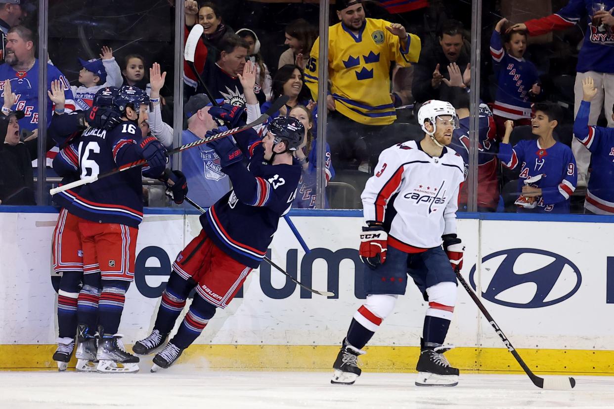 Jan 14, 2024; New York, New York, USA; New York Rangers left wing Artemi Panarin (10) celebrates his goal with center Vincent Trocheck (16) and. left wing Alexis Lafreniere (13) in front of Washington Capitals defenseman Nick Jensen (3) during the first period at Madison Square Garden.