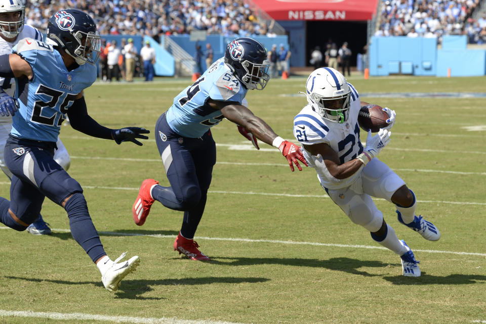 Indianapolis Colts running back Nyheim Hines (21) gets past Tennessee Titans inside linebacker Rashaan Evans (54) as Hines scores a touchdown in the first half of an NFL football game Sunday, Sept. 26, 2021, in Nashville, Tenn. (AP Photo/Mark Zaleski)