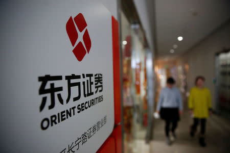 A logo of Orient Securities is seen outside a branch of the company in Shanghai, China, January 26, 2017. REUTERS/Aly Song