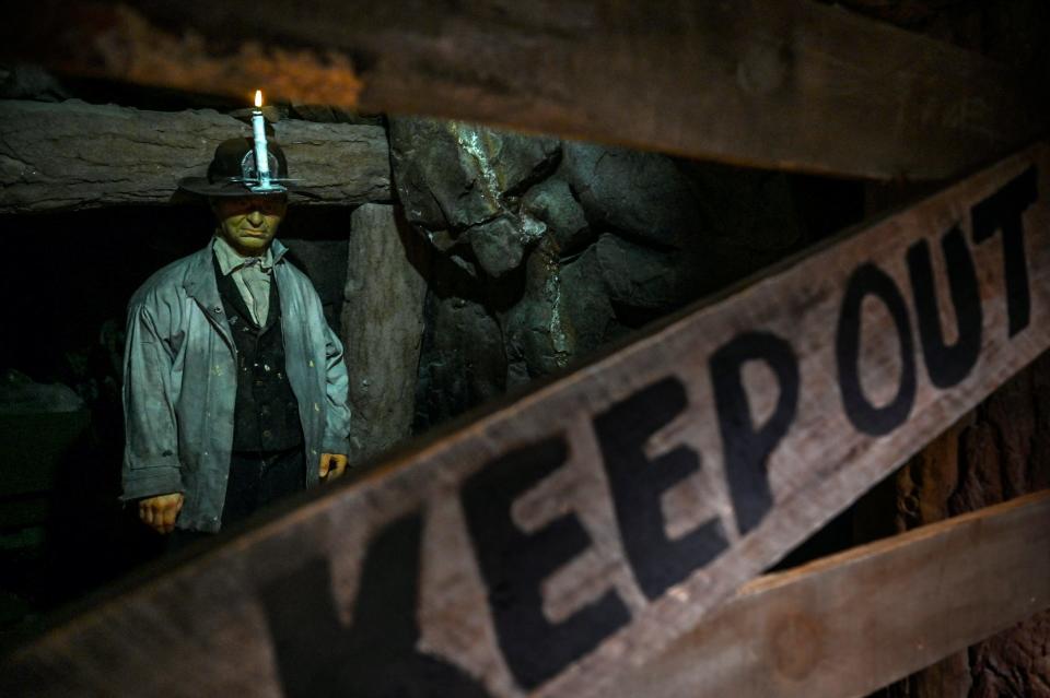 A statue of a miner is seen in a replica cave in the Michigan mining exhibit at the Michigan History Museum on Monday, Nov. 14, 2022, in Lansing.