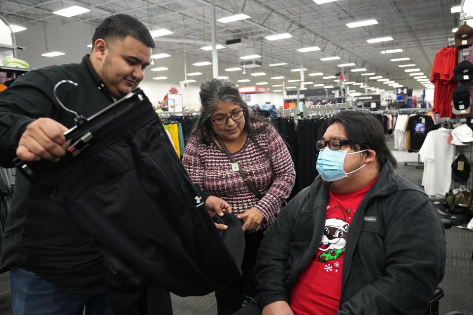 Jacob Jimenez, left, and Michelle Jimenez help Joey Jimenez, right, pick out new sweatpants. Season for Caring was such a blessing to Joey before he died, Michelle Jimenez said, because he knew people cared about him.