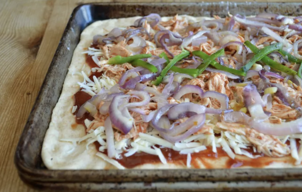 <p>Homemade <a href="https://www.thedailymeal.com/eat/favorite-pizza-chains?referrer=yahoo&category=beauty_food&include_utm=1&utm_medium=referral&utm_source=yahoo&utm_campaign=feed" rel="nofollow noopener" target="_blank" data-ylk="slk:pizza;elm:context_link;itc:0;sec:content-canvas" class="link ">pizza</a> dough can be time-consuming, but once it’s risen and ready to bake, it’s well worth the wait. But for something like this BBQ Chicken Flatbread, you could always use pre-made dough and take a “semi-homemade” approach. Toss cooked and shredded chicken in your favorite barbecue sauce, saute some onions and peppers, spread the sauce on a rectangular rolled-out dough and start topping. Flatbreads are incredibly versatile, and you can make endless variations with or without chicken. </p> <p><a href="https://www.thedailymeal.com/best-recipes/bbq-chicken-flatbread-homemade-recipe?referrer=yahoo&category=beauty_food&include_utm=1&utm_medium=referral&utm_source=yahoo&utm_campaign=feed" rel="nofollow noopener" target="_blank" data-ylk="slk:For the BBQ Chicken Flatbread recipe, click here;elm:context_link;itc:0;sec:content-canvas" class="link ">For the BBQ Chicken Flatbread recipe, click here</a>.</p>