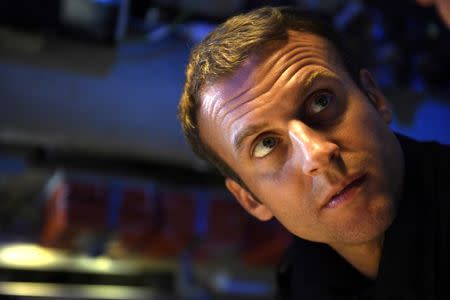 French President Emmanuel Macron listens to explanations in the operations centre of the submarine "Le Terrible", whilst at sea on July 4, 2017. REUTERS/Fred Tanneau/Pool