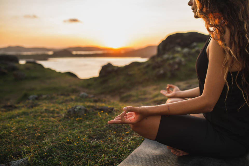 Woman meditating in nature. (Getty Images)