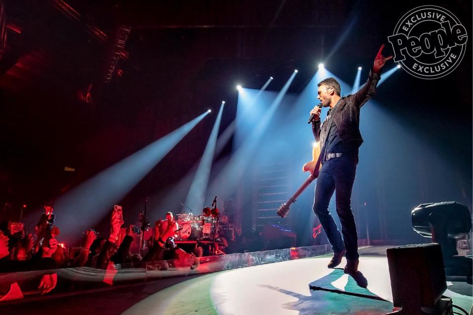 With his trusty guitar slung around his neck, Eric Church greets his adoring crowd on stage in Chicago Saturday night. Before the night was over, Church would play over 40 songs during a three and a half hour music marathon.