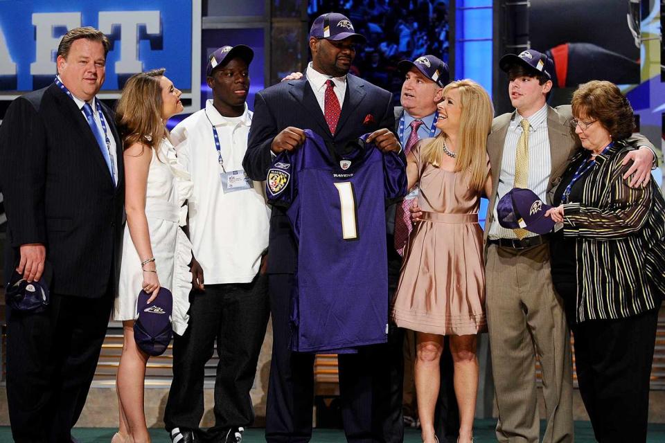 <p>Jeff Zelevansky/Getty</p> Michael Oher with the Tuohy family at the 2009 NFL Draft