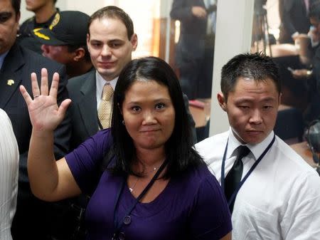 FILE PHOTO: Peru's congresswoman Keiko Fujimori waves to the media as she leaves with her brother Kenji (R) and her husband Mark Vito Villanella after attending the trial of their father, former Peruvian President Alberto Fujimori, at the Special Police Headquarters in Lima, Peru, April 7, 2009. REUTERS/Pilar Olivares/File Photo