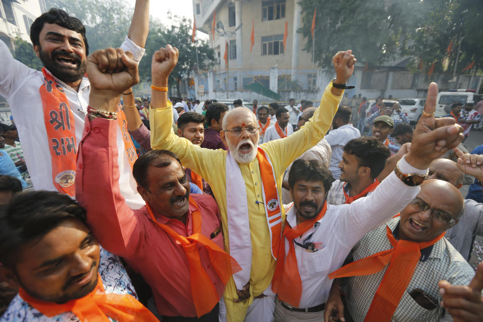 Supporters of Vishwa Hindu Parishad (VHP), or World Hindu Council, celebrate the Supreme Court's verdict outside the VHP office in Ahmadabad, India, Saturday, Nov. 9, 2019. India's Supreme Court has ruled in favor of a Hindu temple on a disputed religious ground and ordered that alternative land be given to Muslims. The dispute over land ownership has been one of the country's most contentious issues. (AP Photo/Ajit Solanki)