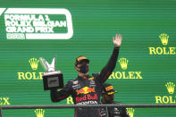First place, Red Bull driver Max Verstappen of the Netherlands, holds up the trophy on the podium after the Formula One Grand Prix at the Spa-Francorchamps racetrack in Spa, Belgium, Sunday, Aug. 29, 2021. The race was red flagged due to weather conditions. (AP Photo/Francisco Seco)