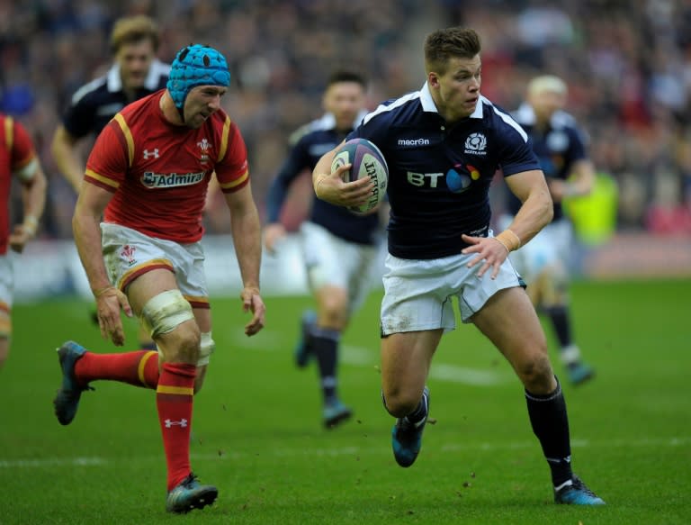 Scotland's center Huw Jones (C) vies with Wales' flanker Justin Tipuric (L) during the Six Nations international rugby union match Febuary 25, 2017