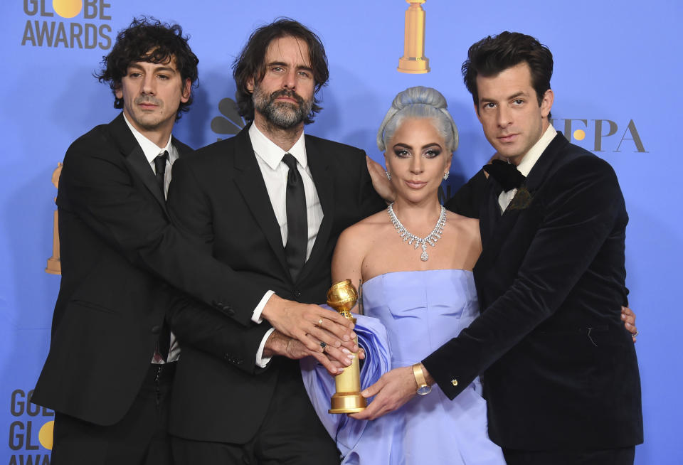 FILE - In this Jan. 6, 2019 file photo, Anthony Rossomando, from left, Andrew Wyatt, Lady Gaga and Mark Ronson pose in the press room with the award for best original song, motion picture for "Shallow" from the film "A Star Is Born" at the 76th annual Golden Globe Awards in Beverly Hills, Calif. The four were also nominated for an Oscar for best original song for "Shallow" on Jan. 22. (Photo by Jordan Strauss/Invision/AP)