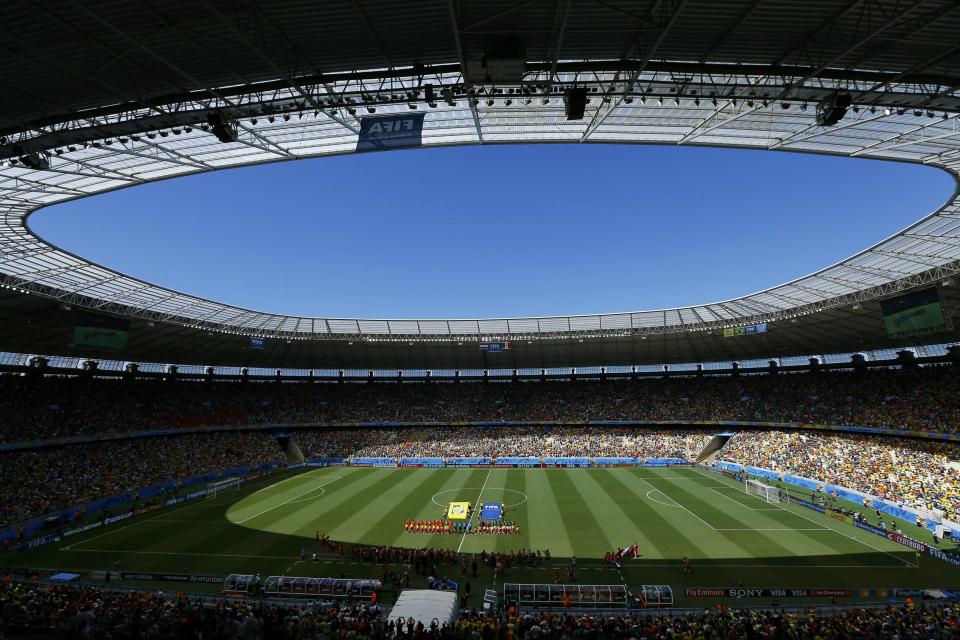 Netherlands and Mexico players stand for the anthems before their 2014 World Cup round of 16 game at the Castelao arena