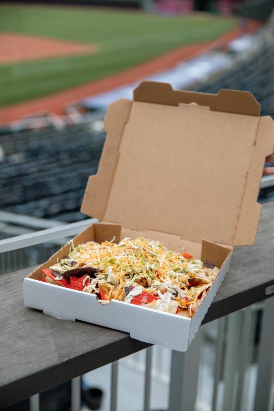 Shareable Nachos — Tostitos chips with a choice of barbecue pulled pork, chipotle chicken or taco beef, served with shredded lettuce, green onions, salsa verde, queso blanco, cilantro lime sour cream and shredded cheese — will be offered in Sections 202 and 234.