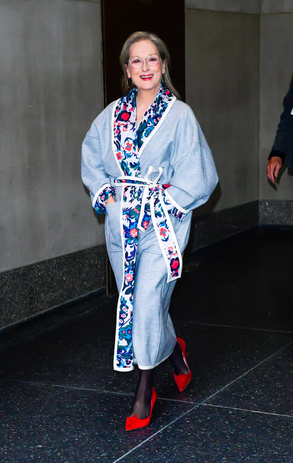 Meryl walking out of the Today show in a printed coat and heels