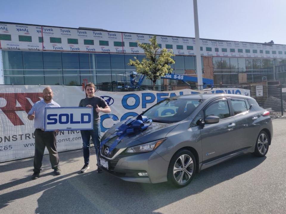 Brennan Loewen posed for a picture on the day he picked up his first ever car, a 2018 Nissan Leaf.