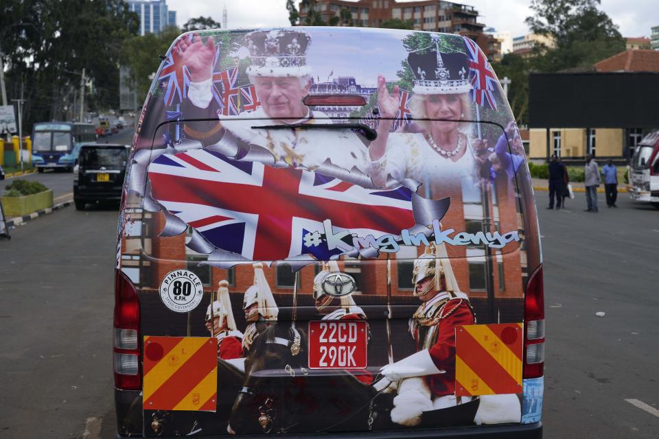 FILE - A view of a matatu adorned with photos of Britain's King Charles III and Queen Camilla ahead of their state visit to Kenya, in Nairobi, Kenya, Oct. 27, 2023. King Charles III wants to look to the future when his four-day state visit to Kenya starts on Tuesday Oct. 31, 2023. But first he will have to confront the past. (AP Photo/Khalil Senosi, file)