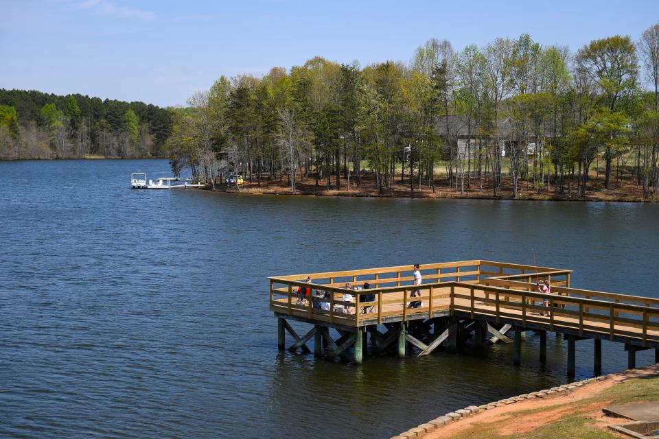 People begin to gather at Lake Cooley Outdoor Education Center before the Partial Eclipse Block Party at the center on Monday, April 8, 2024.