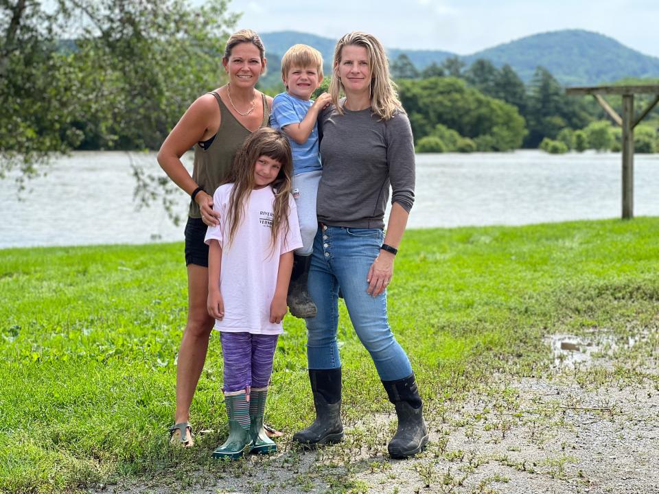 Farmers are resilient, said Alison Conant, right, in front of flood waters that had submerged much of their farm's 300 acres of hay and corn crop and had risen to within 30 or so feet of their dairy cow enclosure on July 11, 2023. Conant Riverside Farms in Richmond has been in Emily Conant Donovan's (left, and sister-in-law to Alison) family since 1854. They intend to weather this storm, literally, and preserve the legacy for generations to come, including C.C, 7, and Merritt, 4.