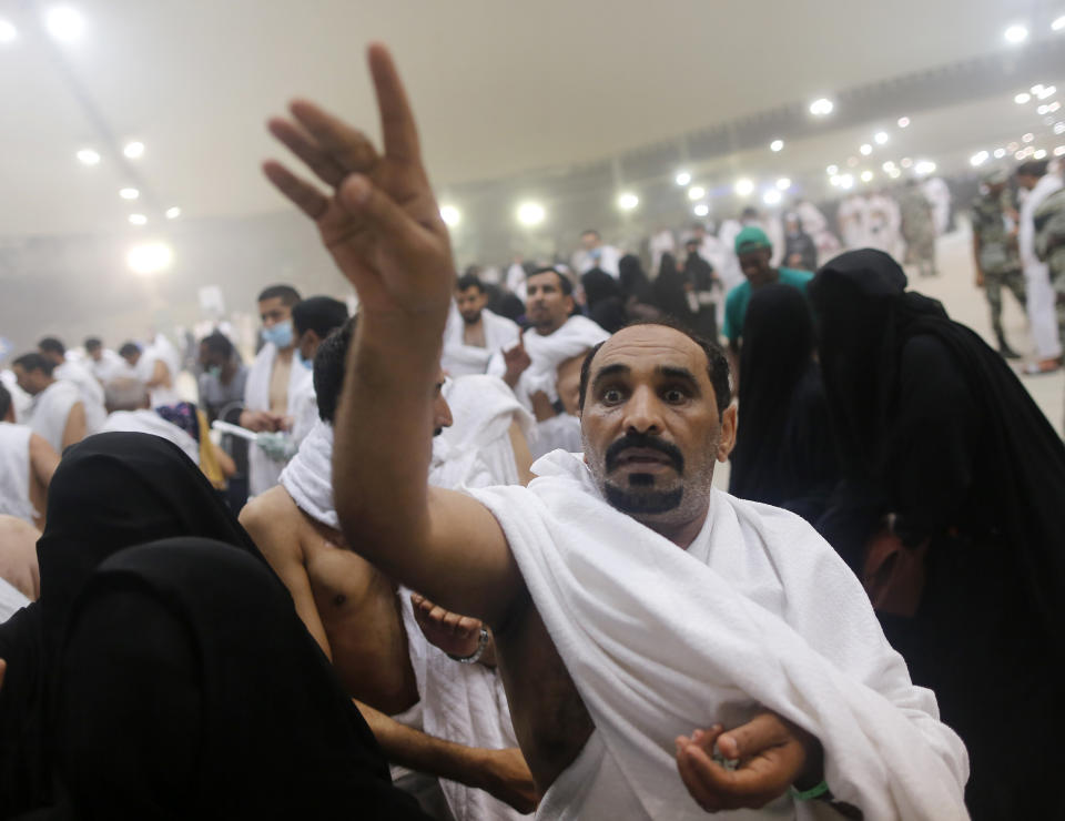 A Muslim pilgrim casts stones at a pillar symbolizing the stoning of Satan, in a ritual called "Jamarat," the last rite of the annual hajj, on the first day of Eid al-Adha, in Mina near the holy city of Mecca, Saudi Arabia, Sunday, Aug. 11, 2019. The hajj is required of all Muslims to perform once in their lifetime if they are financially and physically able. (AP Photo/Amr Nabil)