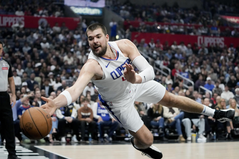 Los Angeles Clippers center Ivica Zubac jumps for a loose ball during the first half of an NBA basketball game against the Sacramento Kings, Sunday, Feb. 25, 2024, in Los Angeles. (AP Photo/Ryan Sun)