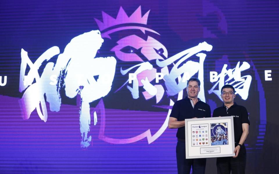 Richard Masters of Premier League and Executive Vice President of Suning Sports Group Wang Dong poses with a gift during PPTV Press conference on July 19, 2019 in Shanghai, China - Fred Lee/Getty Images for Premier League