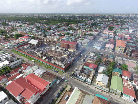 The remains of the Camp Street Prison, after it was destroyed by a fire during a riot, are seen in Georgetown, Guyana, in this July 10, 2017 handout photo taken with a drone. Guyana's Department of Public Information/Handout via REUTERS