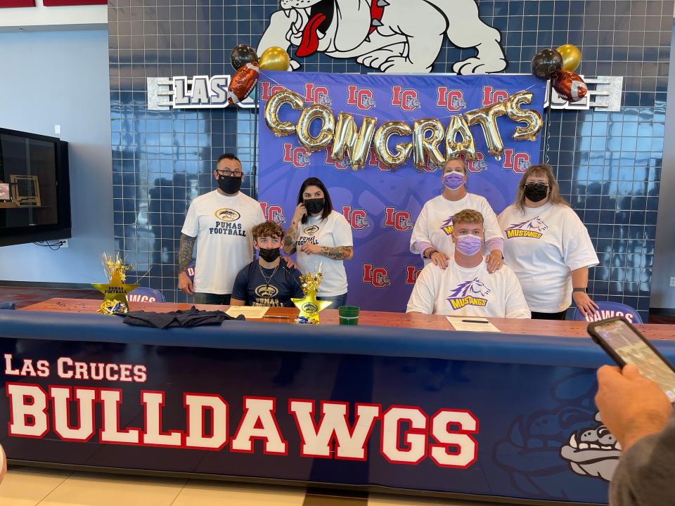 Las Cruces High football seniors Dallas Boyd (left) and Royce Paulk (right) sign with Papago and Western New Mexico on National Signing Day.