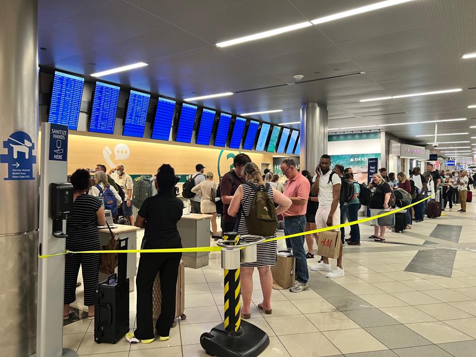 Delta Air Lines passengers wait in line for help at Hartsfield-Jackson Atlanta International Airport on June 19.