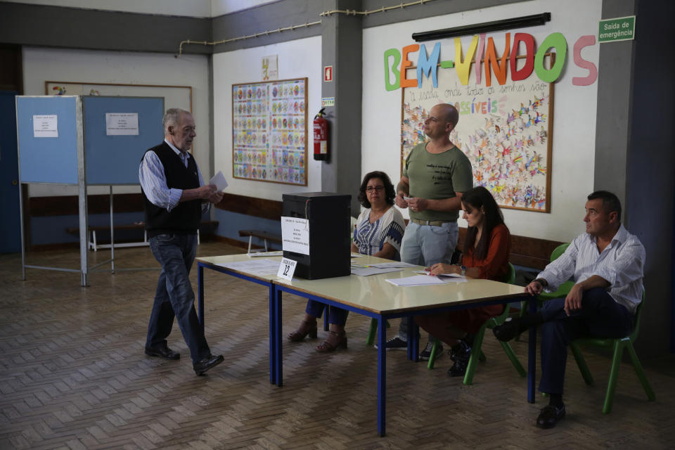 A voter casts his ballot at a polling station in Lisbon Sunday, Oct. 6, 2019. Portugal is holding a general election Sunday in which voters will choose members of the next Portuguese parliament. (AP Photo/Armando Franca)