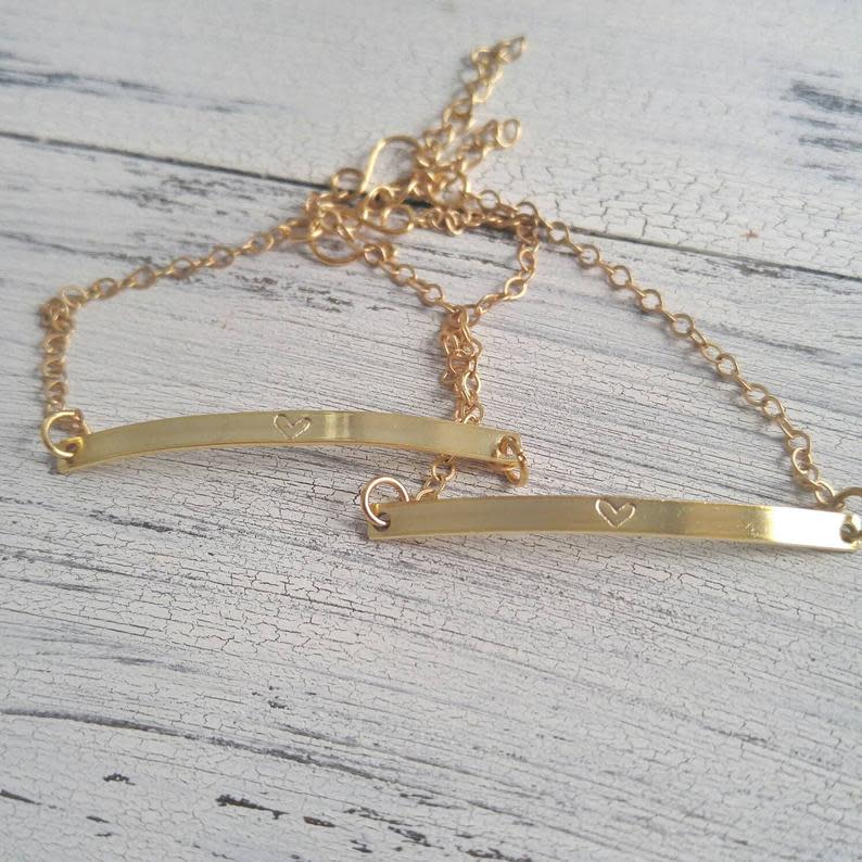 Set of two gold bar bracelets. Image via Etsy.