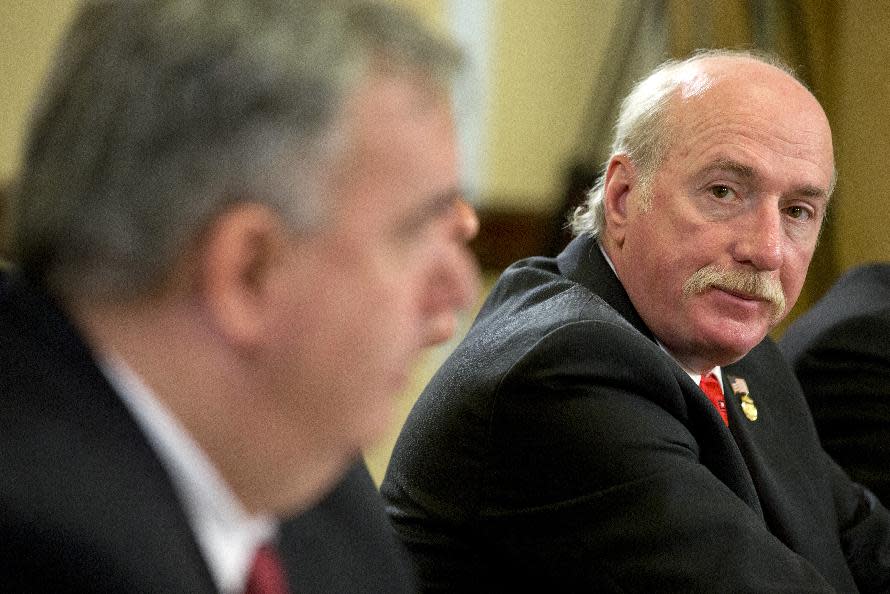 Watertown, Mass. Police Sgt. Jeffrey Pugliese, right, listens to testimony on Capitol Hill in Washington, Wednesday, April 9, 2014, during a Homeland Security Committee hearing about the Boston Marathon Bombings leading up to the year anniversary of the attack. (AP Photo/Jacquelyn Martin)