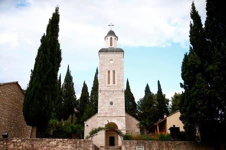 Zitomislic Serbian Orthodox Monastery stands amongst trees in Zitomislici, Bosnia and Herzegovina, July 27, 2017. The monastery dates to 1566, and took more than 40 years to complete. "It is very important that we have here different cultures and religions, and that based on that we can easily build and verify our own identities," Hierodeacon Nektarije said. REUTERS/Dado Ruvic