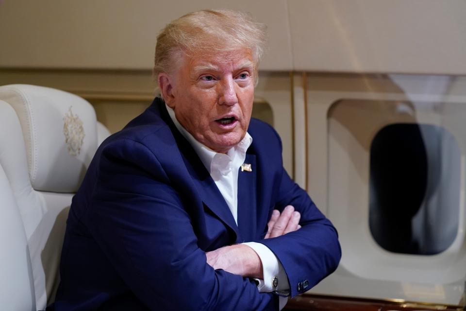 Former President Donald Trump speaks with reporters while in flight on his plane after a campaign rally at Waco Regional Airport, in Waco, Texas, Saturday, March 25, 2023, while en route to West Palm Beach, Fla.