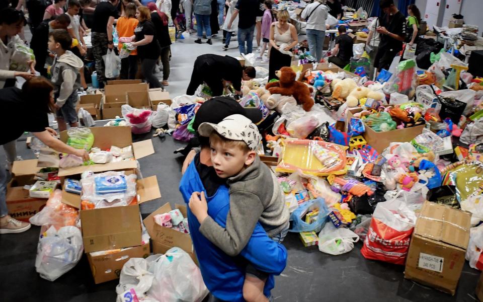 People evacuated from the Belgorod region's zones bordering Ukraine, including those from the town of Shebekino, receive humanitarian aid in Belgorod, - Getty