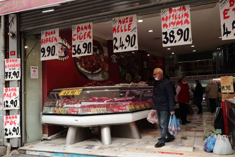 People shop at a meat store in Fatih district in Istanbul