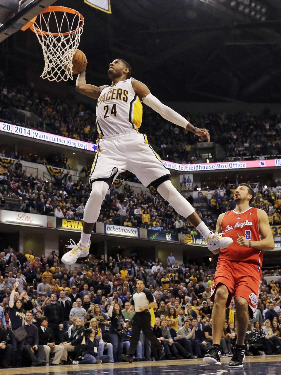 FILE - In this Jan. 18, 2014, file photo, Indiana Pacers forward Paul George (24) dunks in front of the Los Angeles Clippers Hedo Turkoglu (8) during the second half of an NBA basketball game in Indianapolis. Indiana's Paul George and Golden State's Stephen Curry could be first-time starters when the NBA announces the results of fan balloting for the All-Star game on Thursday, Jan. 23, 2013. (AP Photo/AJ Mast, File)