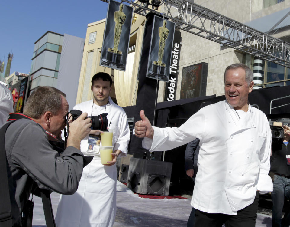 Chef Wolfgang Puck, right, arrives for a Oscar food and beverage preview for the 84th Annual Academy Awards Governors Ball at the Kodak Theatre in Los Angeles on Thursday, Feb. 23, 2012. (AP Photo/Chris Carlson)