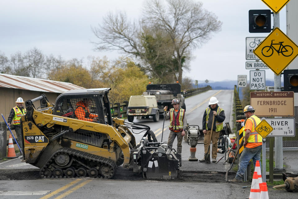 Workers repair damage caused by an earthquake to the Fernbridge in Ferndale, Calif., Wednesday, Dec. 21, 2022. (AP Photo/Godofredo A. Vásquez)