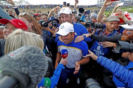 Sep 30, 2018; Paris, FRA; Europe golfer Francesco Molinari is interviewed on the 16th hole while Europe golfer Jon Rahm congratulates him during the Ryder Cup Sunday singles matches at Le Golf National. Brian Spurlock-USA TODAY Sports