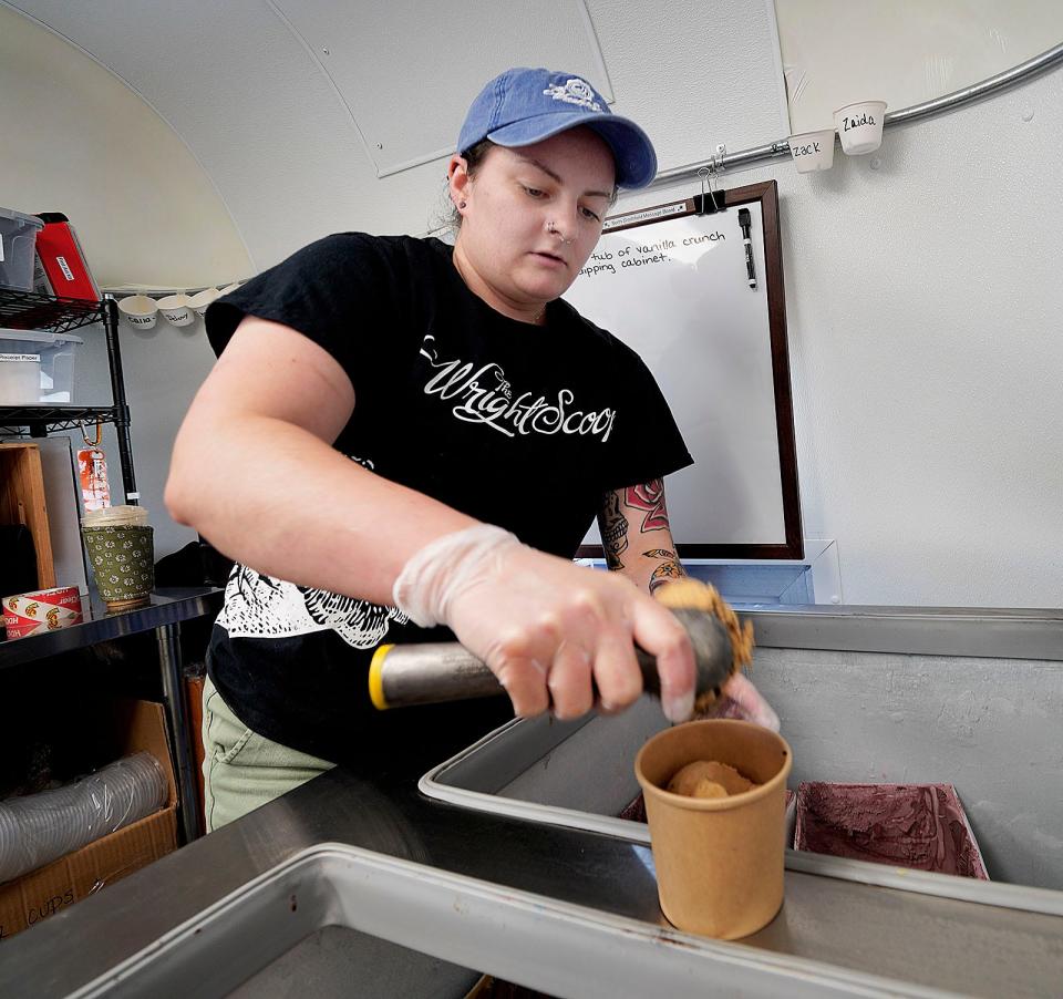 Emilee Flynn, an assistant manager at Wright's Creamery in North Smithfield, scoops coffee Oreo ice cream for a customer.