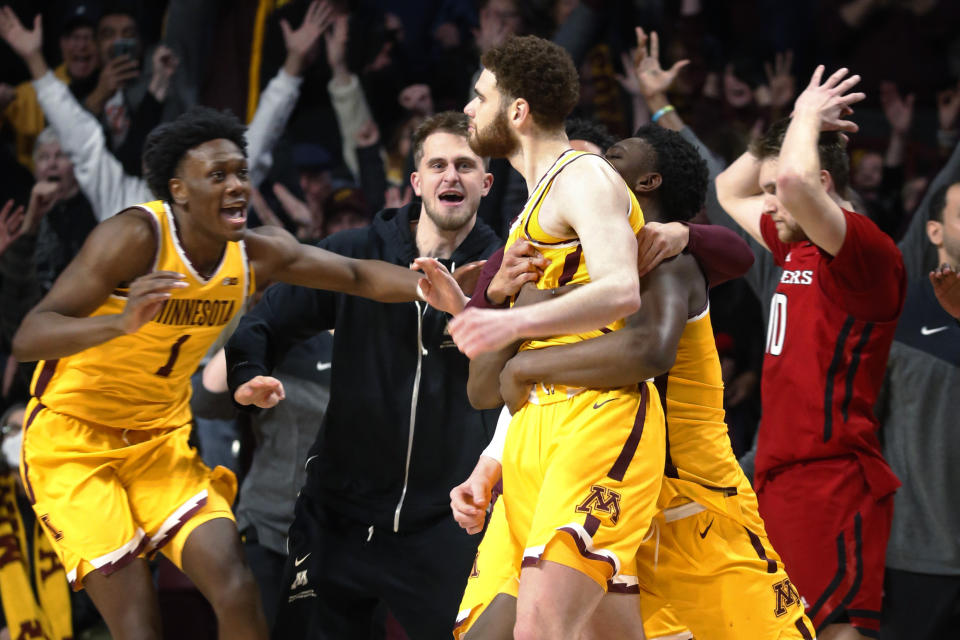 Minnesota forwards Joshua Ola-Joseph (1) and Pharrel Payne, right, celebrate the game-winning 3-point basket by Jamison Battle, center, against Rutgers in an NCAA college basketball game Thursday, March 2, 2023, in Minneapolis. Minnesota won 75-74. (AP Photo/Bruce Kluckhohn)