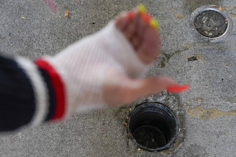 Kim Carlson explains how the sewage line outside her front door constantly backs up due to plumbing issues at the Delta Pines apartment complex, Friday, Nov. 4, 2022, in Antioch, Calif. Despite a landmark renter protection law approved by California legislators in 2019, tenants across the country’s most populous state are taking to ballot boxes and city councils to demand even more safeguards. They want to crack down on tenant harassment, shoddy living conditions and unresponsive landlords that are usually faceless corporations. (AP Photo/Godofredo A. Vásquez)