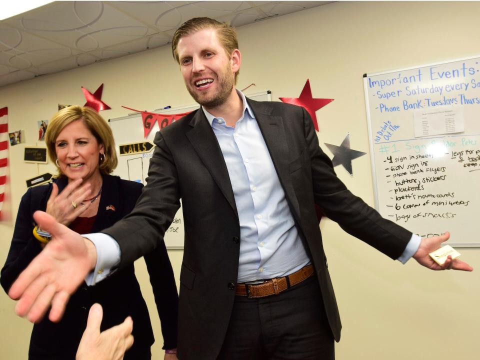 Eric Trump, right, son of President Donald Trump, enters a rally for U.S. Rep. Claudia Tenney