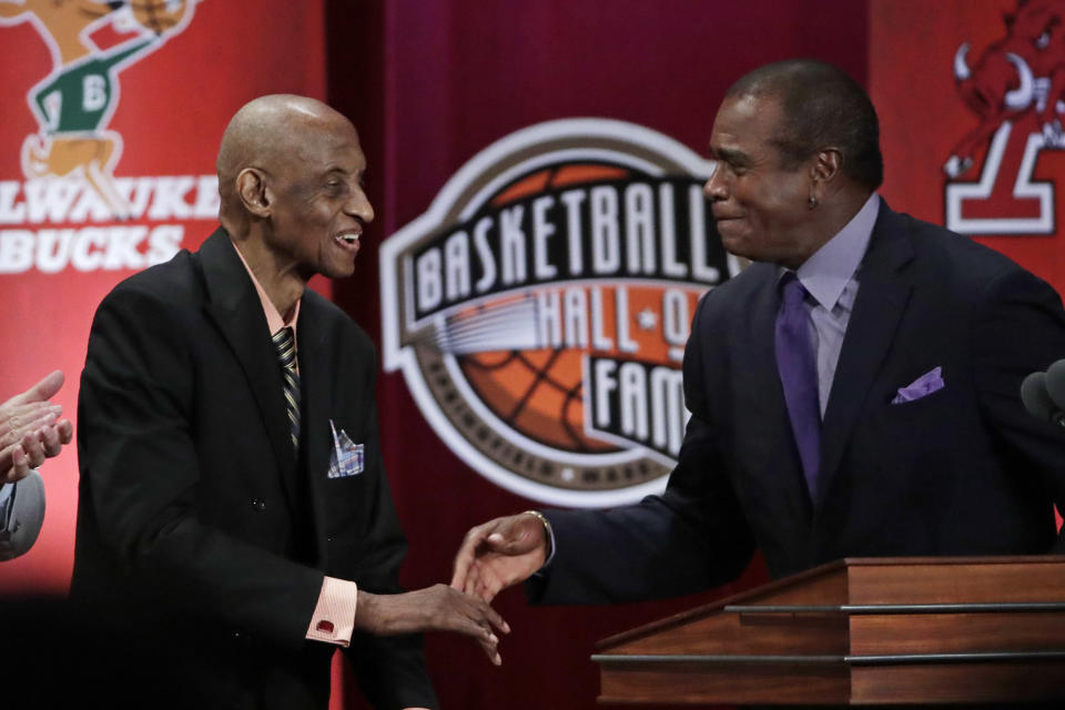 FILE - Inductee Dick Barnett, left, shakes hands with host Ahmad Rashad at the Basketball Hall of Fame enshrinement ceremony in Springfield, Mass., Friday, Sept. 6, 2019. The AP poll has had a simple mandate over its 75 years of existence: pick the best teams in the country each week. Those teams now all come from the NCAA’s Division I membership. But in the poll’s earliest days — especially before most historically Black institutions were considered NCAA members — the lines were a bit more blurred. (AP Photo/Elise Amendola, File)