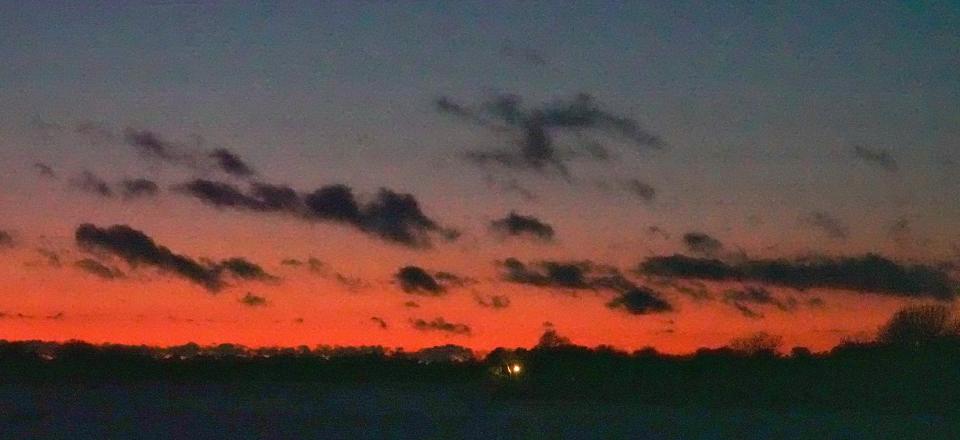After a stormy snowy day the clouds left a colorful sunset over Cape Cod Airfield in this January of 2022 file photo.