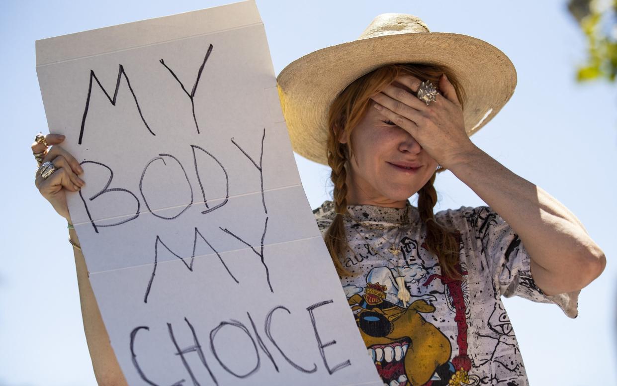 A pro choice demonstrator reacts while holding a poster reading 'My body my choice' during a protest following the decision by the US Supreme Court to overturn the Roe v. Wade ruling - ETIENNE LAURENT/EPA-EFE/Shutterstock