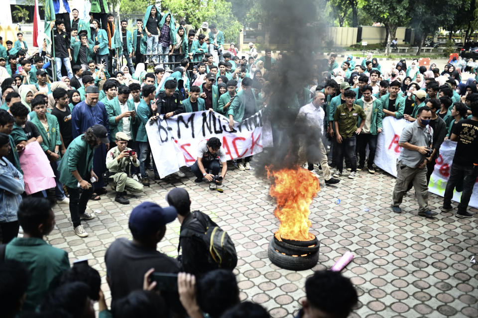 Protesters burn tires during a protest rejecting Rohingya refugees in Banda Aceh, Aceh province, Indonesia, Wednesday, Dec. 27, 2023. Students in Indonesia's Aceh province rallied on Wednesday demanding the government drive away Rohingya refugees arriving by boat in growing numbers as police named more suspects of human trafficking. (AP Photo/Reza Saifullah)